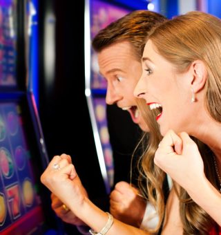 Couple in Casino on a slot machine